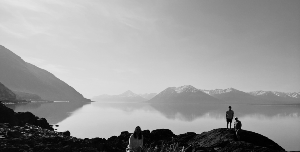 Serene black and white landscape with mountains and water